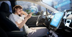 Woman using smart phone in autonomous car Woman using smart phone in autonomous car